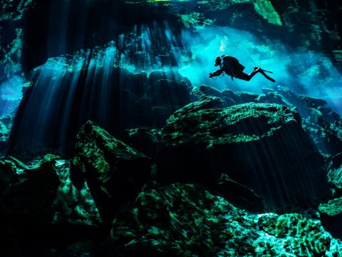 Scuba diver exploring the underwater caverns.